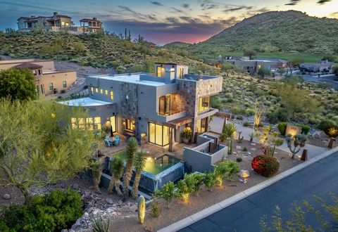 Nestled within the prestigious Vista Del Corazon enclave in sought-after Gold Canyon, this residence transcends the ordinary, epitomizing the essence of ultra-modern living. Perched on a hillside, immerse yourself in breathtaking vistas of majestic m...
