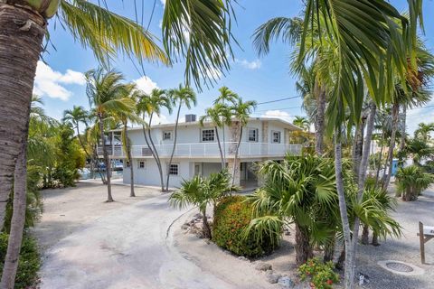 Venetian Shores all concrete home with 100 ft. of deep-water dockage, located in one of the most sought-after subdivisions in Islamorada. Upstairs is 2/2 with open floor plan, high ceilings, and a spacious screen porch overlooking the water, the lowe...