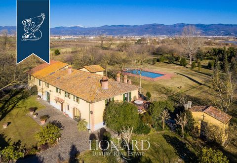 In Prato's countryside there is this lovely luxury property currently up for sale. This two-floored luxury villa enjoys a free sight on all its sides and has the typical looks of a Tuscan estate with red-bricked arches, wooden beams, stone stair...