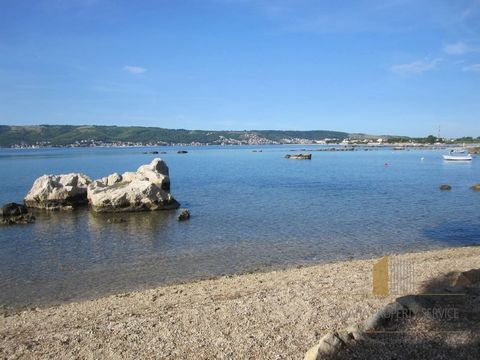 Apartment house in an exclusive location, real first row by the sea and the beach. Attractive location between famous tourist centers, Trogir and Split. Split Airport is 800 m away. The special feature of the location is its distance from the main ro...