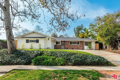 Enter this sprawling ranch style home with a mid-century vibe. The main open living space is characterized by a soaring high pitched beam ceiling and is both spacious and welcoming. Enjoy the panoramic view of the extensive flat backyard featuring a ...