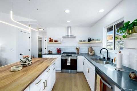 Presenting a FULLY REMODELED designer home with panoramic basin and mountain views in Joshua Tree's coveted Upper Friendly Hills neighborhood. Nestled just minutes from the West Gate entrance of Joshua Tree National Park, this property offers an unpa...
