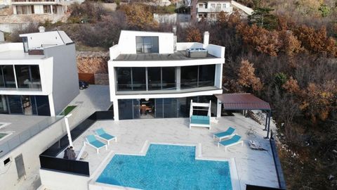 Impressive modern villa in a great location above the town of Crikvenica with fantasic views. The villa has a spectacular view of the sea and the island of Krk. Total area is 260 sq.m. Land plot is 500 sq.m. It consists of an entrance hall on the gro...