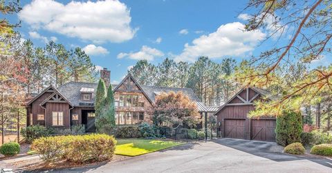 Nestled on a beautiful 2.84-acre lot overlooking the 6th green of The Reserve at Lake Keowee Jack Nicklaus signature golf course, this home with guest house is truly one of a kind. Completely updated, this mountain contemporary home graciously expand...