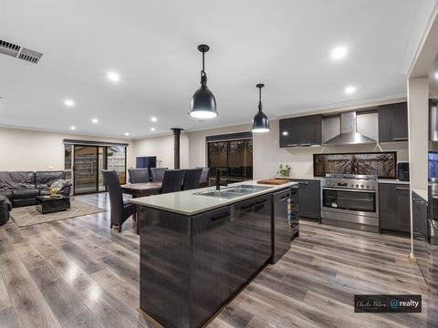 Here is a home with a lot to offer the modern family. This contemporary residence features a generous amount of living space under roof, including three living areas. The modern and sleek kitchen is every chef's dream, featuring large, S/S appliances...