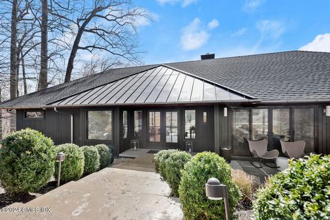 Set on ''Bull Frog Pond'' completely renovated custom designed contemporary home with open spaces, walls-of-glass and vaulted ceilings lending itself for extraordinary indoor/outdoor experiences. Accented by custom cabinetry, intricate stone material...