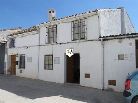 This 3 bedroom traditional townhouse, which would have been two up and two down now with a kitchen and bathroom extension, in Alcaudete, Jaén province of Andalucia, Spain. Enter the front door into the living room with the stairs going up on the left...
