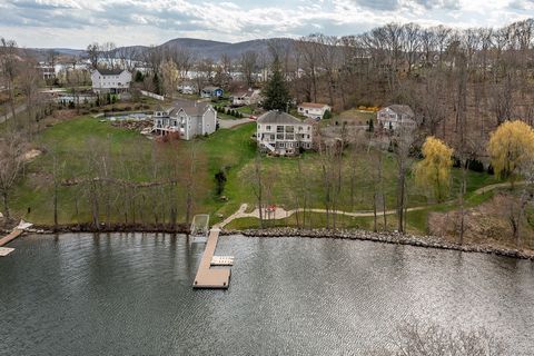 Exceptional Candlewood Lake Waterfront, custom built in 2006, boasts a prime location, on a level lot with open lake views, a golf cart path to water's edge & rolling lawn to a private dock w/boat lift, jet ski docks & patio lakeside. Impeccably main...