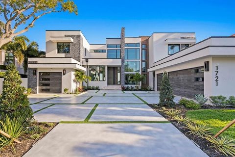 STUNNING COMPLETED NEW CONSTRUCTION! Live the dream in this modern masterpiece boasting state-of-the-art design, exquisite finishes, and 100' of water frontage with breathtaking open views of Tampa Bay. This spectacular Brightwaters Blvd. gated estat...