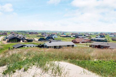 In the 1st row to the ocean, right behind the dunes, is this holiday cottage approx. 50 m from the North Sea. Open concept kitchen and living room with TV with i.a. international channels and wood-burning stove. Well-equipped kitchen with i.a. cerami...