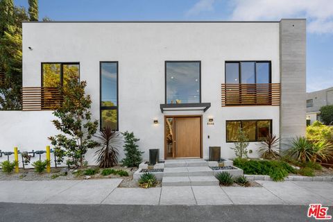 On a quiet tree-lined street in the Hollywood Hills, this newly rebuilt, exquisite Laurel Canyon original showcases warm, contemporary architecture that beautifully melds sophistication and simplicity. Gated and hedged for privacy, the five-bedroom r...