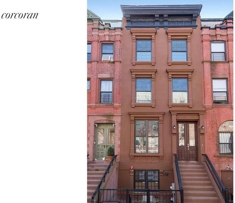 This classic brownstone has 4 bedrooms, 4.5 exquisitely tiled bathrooms, oak floors throughout, washer/dryer/ central air/ full finished cellar in a brand new interior. A four-story one-family home is located on a central Harlem block graced with a b...