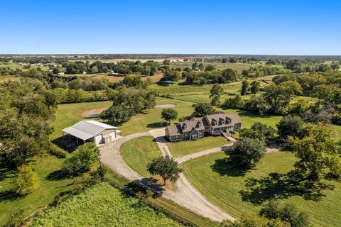 Perfection in the heart of Fulshear, Texas! This beautiful custom-built 1.5 story farmhouse sits on 10 unrestricted acres of land with a gated entrance. Enjoy sunrise over mature trees and beautiful pastures, while egrets and blue herons gather aroun...