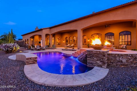 This elegant North Scottsdale custom estate is located on a private lot in a gated community. Outside, there are exquisite mountain & sunset views with open desert space behind. The expansive travertine covered patio, heated solar pool & spa, built-i...