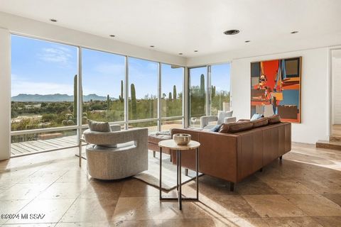 Sited on over an acre, this Midcentury Adobe home was designed by architect Dave Fraker. Abundant windows and a sprawling open plan position this home for premium views of our Tucson mountains and city lights. Floor to ceiling glass and modern design...