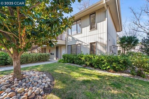 Light and bright LEVEL IN! Cypress model overlooking large flat grassy front courtyard and perfectly situated steps away from carport, storage unit, guest parking and laundry room. MORE PHOTOS COMING! Enjoy kitchen with updated lighting, white cabine...