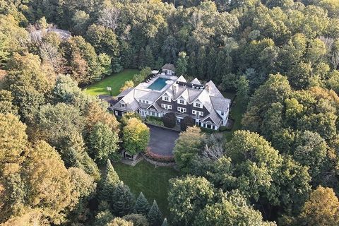 Extraordinary shingle style home designed by prominent architect on over 2 acres of incredible land. Over 11,400 sq ft of living space on 4 floors. Features include remarkable theater w/ gold leaf and 9 ft screen, billiard room w/ oversized bar & fir...