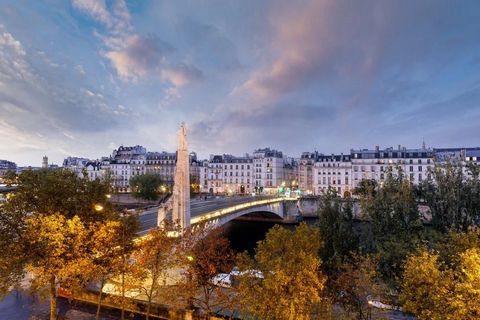 Discover this elegant apartment along the banks of the Seine, offering an exceptional view of Paris, its monuments, and the Seine. A spacious living room with a fireplace, featuring large river-facing windows, and a modern open kitchen with a dining ...