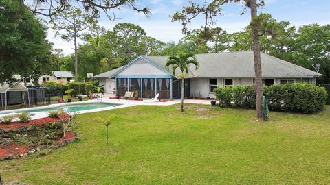 This single-story CBS pool home nestled on 1.25 acres in the prime location of Jupiter Farms offers a lifestyle of comfort and freedom. With 4 bedrooms, 2 bathrooms, and a 2-car garage, this home presents an inviting space for relaxation and entertai...