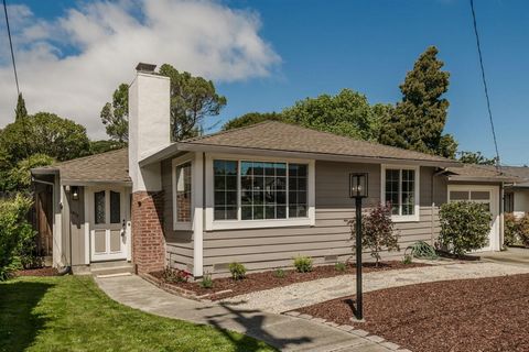 Rooms to Grow! This spacious haven offers a perfect balance of modern convenience & mid-century charm. Hardwood floors warmly glow & modern lighting fixtures illuminate the space. An inviting living room w/ wood-burning fireplace & adjoining dining r...