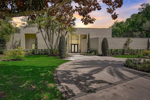 This modern magnificent mansion sprawls across nearly two acres of lush landscape in a coveted guard gated community. With 8 bedrooms, 6.5 bathrooms + a bonus room, guest house and a 3 car garage, this home offers ample space for luxurious living. Li...