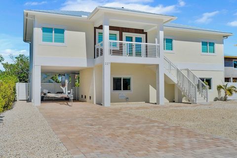 YOUR ULTIMATE KEYS GETAWAY... has just been found!!! Welcome to ''Paradise Point'', Like-New, Built in 2023, this solid CBS waterfront home is in the new subdivision of Coco Plum Estates. This contemporary OPEN CONCEPT layout, 4 bedroom /3 bath home,...