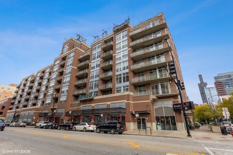 Sunny West Loop loft! This two bedroom, two bathroom loft is complete with hardwood floors and an open kitchen with island, granite countertops, and stainless-steel appliances. The primary bathroom has double sinks, a separate shower, and soaking tub...