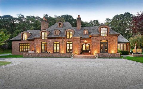 Set on 6.97 acres in the village of Matinecock, this ultimate family estate has been designed for entertainment. Although the exterior makes a formal red-brick statement, the interior exudes a transitional and modern style. From arched doors to panel...