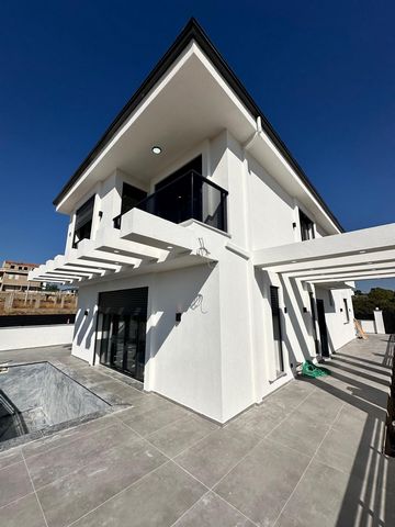 This stunning villa for sale in Didim stands out with its modern design and spacious living areas. The villa features 3 bedrooms, 3 bathrooms, a large living room, a modern kitchen, and elegant interior details. The villa's spacious balconies are per...