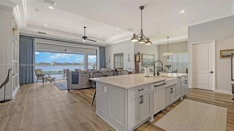 Welcome to luxurious lakefront living in Nokomis, FL's esteemed Aria subdivision. This opulent home boasts custom cabinets, exquisite floors, private resort like pool, outdoor kitchen and entertainment area, 3-car garage, impact windows and doors, hi...