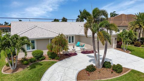 PUNTA GORDA ISLES - COASTAL COOL, SPACIOUS AND UPDATED 4 BEDROOM, WATERFRONT, CANAL AND POOL HOME WITH POWERBOAT ACCESS TO CHARLOTTE HARBOR AND THE GULF OF MEXICO! YOU WILL LOVE THE COASTAL VIBE OF THIS HOME WITH ITS LARGE KITCHEN WITH GRANITE COUNTE...