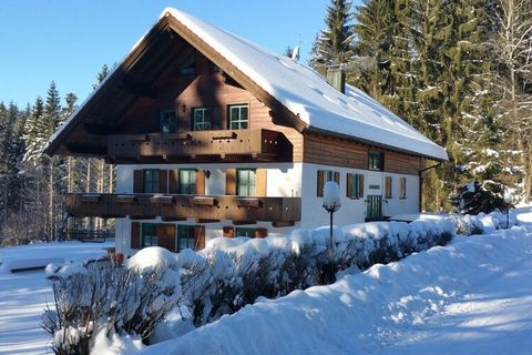 Comfortable holiday apartment in a secluded location in a forest clearing in a rustic country house style with a large balcony.