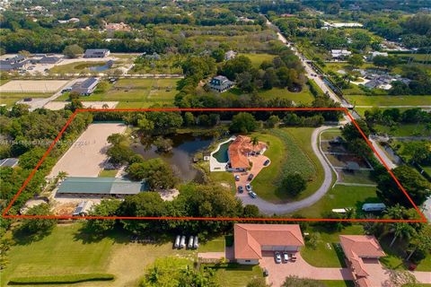 Motivated Seller. Immerse yourself in the epitome of equestrian luxury on nearly 5 acres in Sunshine Ranches. This meticulously crafted estate showcases a main residence, guest house/office, and a spacious stable with 18 partitions. Enjoy the conveni...
