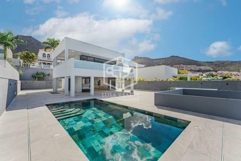 Brand new villa for sale in El Madroñal, Costa Adeje. Built on a plot of 545 m2, the villa consists of 3 levels. The main level has a huge living room with an open plan kitchen and a guest toilet, which leads out onto a large covered terrace overlook...