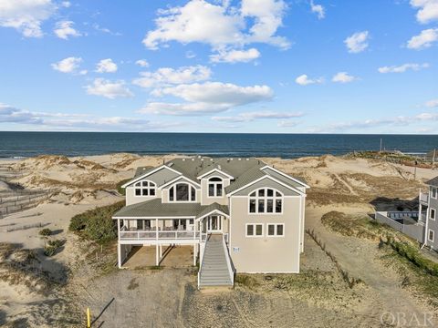 Indulge in the serene beauty of nature and sweeping ocean views in this grand oceanfront retreat situated on a 3-acre lot in the coveted 4x4 section of Corolla. With almost 8000 square feet of living space, this home is meticulously designed to comfo...