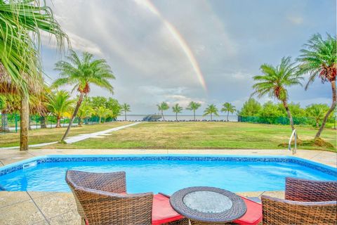 THE LAID-BACK LOWER KEYS ARE CALLING YOU ... experience life at a slower pace on this .81 acre open water estate with a 2-bedroom, 2-bath main house as well as a 1-bedroom, 1-bath guest cottage overlooking Bogie Channel. Entertain in the large, pools...