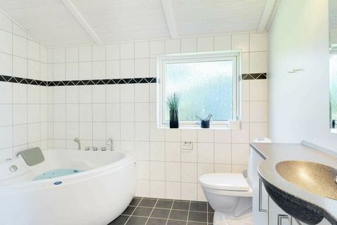 Holiday cottage with a tasteful furnishing in a modern design located n a large natural plot only a few minutes walk from probable the best beach in Denmark. The house suits both one or two families sharing and has all modern amenities. Living room w...