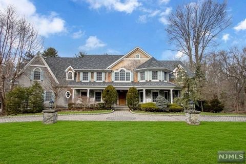 Classic Saddle River estate w/ bright eastern exposure on 2 acre private, wooded property with a semi-circular paver dw. Located on a desirable double cul-de-sac in the heart of town. Grand 2 sty EF opens into the 2 sty GR w/ FPL. This room is sun fi...