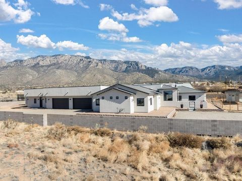 Experience luxury living with stunning Sandia Mountain views in this custom-built home on a .89-acre lot. Featuring 3 bedrooms, a 1-bedroom guest house, and premium amenities, this home offers both style and comfort.Enjoy a theater room, gym, office,...