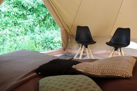 This beautiful large Glamour tent stands on a wooden platform and is tastefully decorated. A small fire pit has been created next to the tent, with a tripod with a pan above it. When you unzip the back entrance of the tent, the made-up spacious doubl...