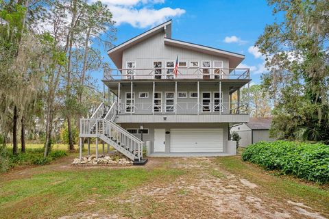 Bring your boat, your RV, and all your other toys! This custom-built home on a private island in Lake Griffin has room for it all. This beautifully crafted four-bedroom, three-bath home with a private dock and direct access to the Harris Chain of Lak...