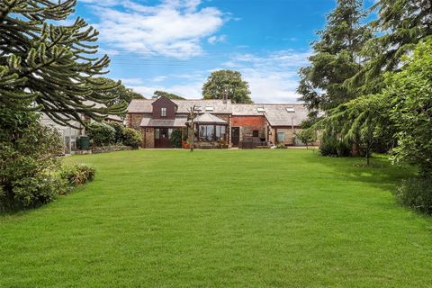 A gate from the parking opens onto a good-sized terrace that overlooks the gardens to the fields beyond. The property offers external elevations of brick and stone under a slate roof. A part glazed front door leads into the entrance vestibule with sp...