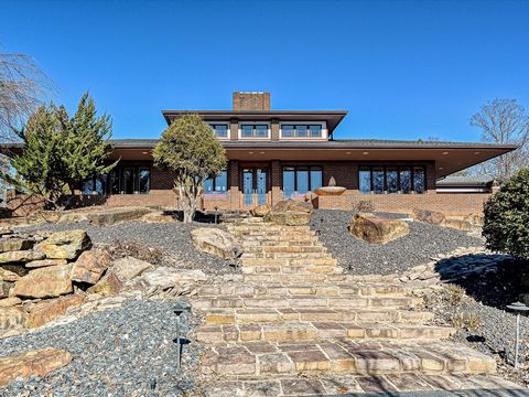 This remarkable NC equestrian retreat boasts equal delights for humans, horses, & dogs. Ingeniously integrated into natural surroundings, the Frank Lloyd Wright-inspired Prairie style estate presides over sculpted grounds, pastures, ponds, barns & En...