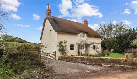 A wonderful extended and improved Grade II listed 3 bedroom thatched cottage of immense character and charm set in surrounding gardens with two large outbuildings providing garaging, workshop and studio/hobbies room with sauna, shower room and with e...