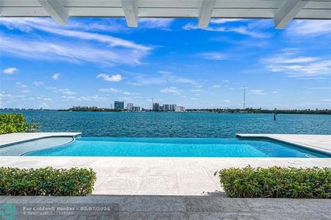 Stunningly Beautiful Sunrises from this Contemporary Bayfront Residence with an impressive 150' of unobstructed views and for the boater 138' of protected canal frontage with a dock, two boat lifts & easy access to the ocean. Immediate views upon ent...