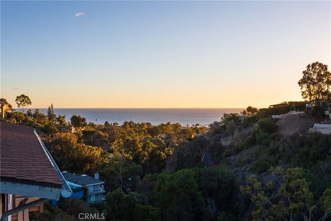 Warm and contemporary, this custom Laguna Beach home redefines ocean-view living in Lower Bluebird Canyon. Overlooking a dramatic canyon, this 3-bedroom home is nestled on an inviting cul-de-sac and offers beautiful views of the Pacific Ocean, evenin...
