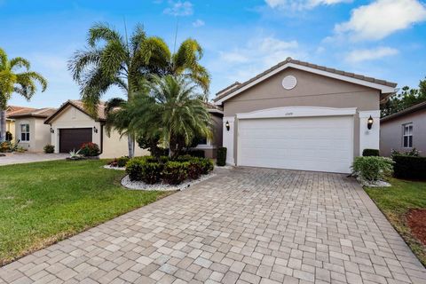 This rarely available ''Bimini'' model is situated on a lushly landscaped private lot boasting Impact windows & doors, diagonally laid Porcelain Tile flooring, Coffered ceilings, Designer light fixtures, fans, and window treatments. Granite kitchen f...