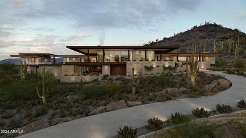 The Six Shooter residence seamlessly floats in harmony with the natural landscape through carefully selected rustic materials, such as rubble stone, concrete and raw steel. Perched high on the gentle hillside, this home offers panoramic views and ult...