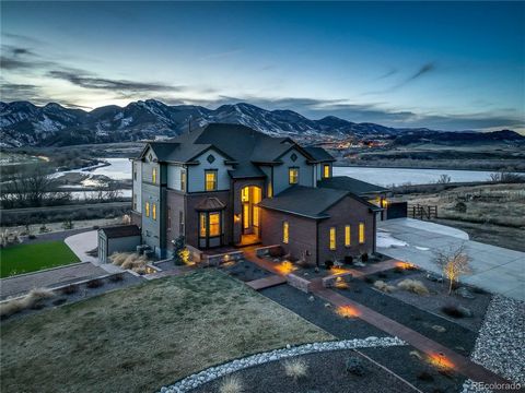 Found within the prestigious Estates at Chatfield Farms, where luxury living meets the breathtaking beauty of Colorado's Rocky Mountains. Step inside to discover a home bathed in natural light, where a grand spiral staircase and rich hickory floors s...