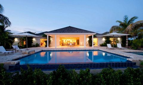 Located in Jolly Harbour. Antigua Palm Point is a luxurious beachfront villa with spacious open plan living areas. The entrance porch leads into a central hub of the villa. From here the white ceramic Italian tiles continue straight onto the white sa...